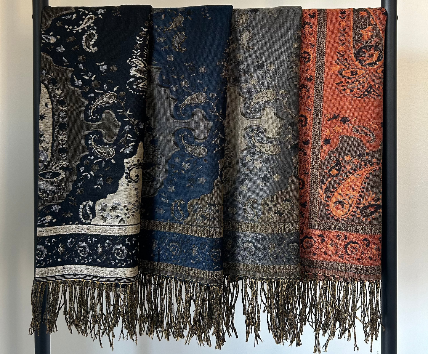 Lula Scarves in Silver Mist, Black, Deep Navy, and Pumpkin Spice - a versatile selection of classic and seasonal colors, highlighting the soft texture and elegant drape of each scarf. Ideal for adding warmth and style to any outfit.