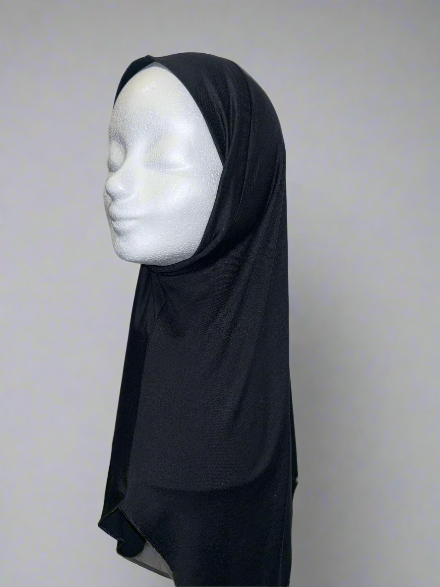 Side view of the Neck-Covering Undercap in black on a mannequin, highlighting the seamless design and soft, breathable cotton fabric.